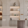 Inspirasi desain interior ruang kerja minimalis yang elegan. Menampilkan rak dinding dengan pencahayaan LED tersembunyi, menggunakan paduan HPL Taco kodeTH 068 SA Comfort Grey dan TH 069 SA Sea Salt. Terdapat meja dengan aksen teraso, dekorasi buku, patung kuda, dan lampu meja brass